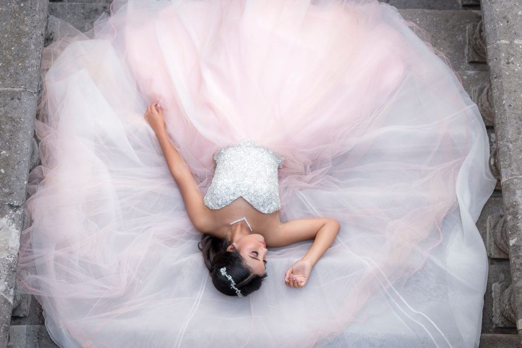 Top view of a woman in a beautiful flowing gown, resting gracefully.